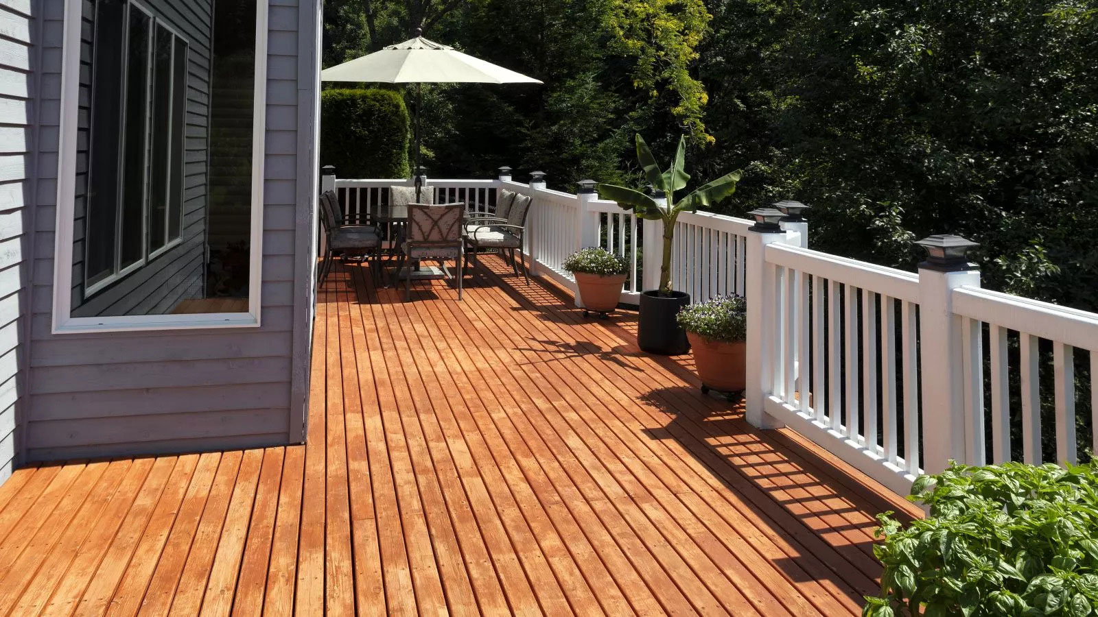 Brown Dirty Deck in Front of Gray Home